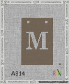 A taped needlepoint canvas with the design: Banner 13 mesh count Squared M White on Brown.