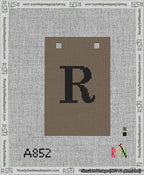 A taped needlepoint canvas with the design: Banner 13 mesh count Squared R Black on Brown.