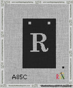 A taped needlepoint canvas with the design: Banner 13 mesh count Squared R White on Black.