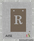 A taped needlepoint canvas with the design: Banner 13 mesh count Squared R White on Brown.