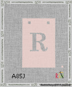A taped needlepoint canvas with the design: Banner 13 mesh count Squared R White on Pink.