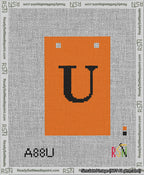A taped needlepoint canvas with the design: Banner 13 mesh count Squared U Black on Orange.
