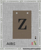 A taped needlepoint canvas with the design: Banner 13 mesh count Squared Z Black on Brown.