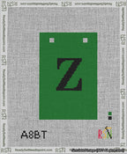A taped needlepoint canvas with the design: Banner 13 mesh count Squared Z Black on Green.