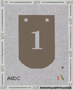 A taped needlepoint canvas with the design: Banner 18 mesh count Curved 1 White on Brown.