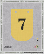 A taped needlepoint canvas with the design: Banner 18 mesh count Curved 7 Black on Yellow.