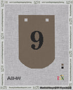 A taped needlepoint canvas with the design: Banner 18 mesh count Curved 9 Black on Brown.