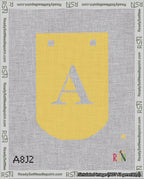 A taped needlepoint canvas with the design: Banner 18 mesh count Curved A White on Yellow.