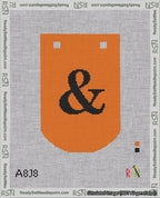 A taped needlepoint canvas with the design: Banner 18 mesh count Curved Ampersand Black on Orange.
