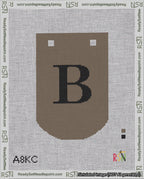 A taped needlepoint canvas with the design: Banner 18 mesh count Curved B Black on Brown.