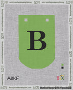 A taped needlepoint canvas with the design: Banner 18 mesh count Curved B Black on Light Green.