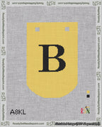 A taped needlepoint canvas with the design: Banner 18 mesh count Curved B Black on Yellow.