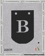 A taped needlepoint canvas with the design: Banner 18 mesh count Curved B White on Black.