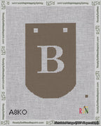 A taped needlepoint canvas with the design: Banner 18 mesh count Curved B White on Brown.