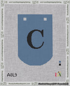 A taped needlepoint canvas with the design: Banner 18 mesh count Curved C Black on Blue.
