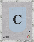 A taped needlepoint canvas with the design: Banner 18 mesh count Curved C Black on Light Blue.