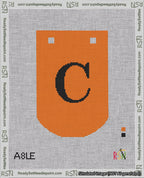 A taped needlepoint canvas with the design: Banner 18 mesh count Curved C Black on Orange.