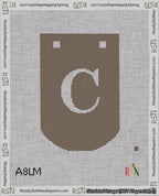 A taped needlepoint canvas with the design: Banner 18 mesh count Curved C White on Brown.