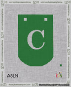 A taped needlepoint canvas with the design: Banner 18 mesh count Curved C White on Green.