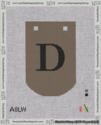 A taped needlepoint canvas with the design: Banner 18 mesh count Curved D Black on Brown.