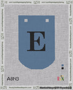 A taped needlepoint canvas with the design: Banner 18 mesh count Curved E Black on Blue.