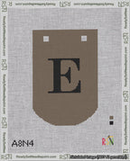 A taped needlepoint canvas with the design: Banner 18 mesh count Curved E Black on Brown.