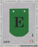 A taped needlepoint canvas with the design: Banner 18 mesh count Curved E Black on Green.