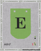 A taped needlepoint canvas with the design: Banner 18 mesh count Curved E Black on Light Green.