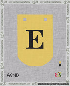 A taped needlepoint canvas with the design: Banner 18 mesh count Curved E Black on Yellow.