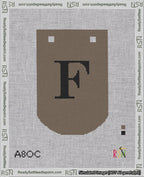 A taped needlepoint canvas with the design: Banner 18 mesh count Curved F Black on Brown.