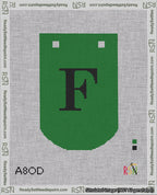 A taped needlepoint canvas with the design: Banner 18 mesh count Curved F Black on Green.