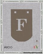A taped needlepoint canvas with the design: Banner 18 mesh count Curved F White on Brown.