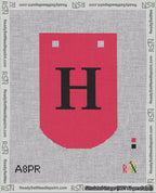 A taped needlepoint canvas with the design: Banner 18 mesh count Curved H Black on Red.