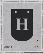 A taped needlepoint canvas with the design: Banner 18 mesh count Curved H White on Black.