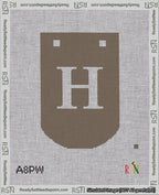 A taped needlepoint canvas with the design: Banner 18 mesh count Curved H White on Brown.