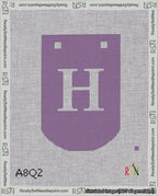 A taped needlepoint canvas with the design: Banner 18 mesh count Curved H White on Purple.