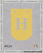 A taped needlepoint canvas with the design: Banner 18 mesh count Curved H White on Yellow.
