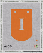 A taped needlepoint canvas with the design: Banner 18 mesh count Curved I White on Orange.