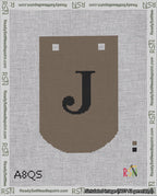 A taped needlepoint canvas with the design: Banner 18 mesh count Curved J Black on Brown.