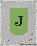 A taped needlepoint canvas with the design: Banner 18 mesh count Curved J Black on Light Green.