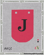 A taped needlepoint canvas with the design: Banner 18 mesh count Curved J Black on Red.