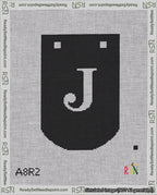 A taped needlepoint canvas with the design: Banner 18 mesh count Curved J White on Black.