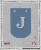 A taped needlepoint canvas with the design: Banner 18 mesh count Curved J White on Blue.