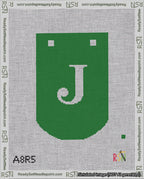 A taped needlepoint canvas with the design: Banner 18 mesh count Curved J White on Green.