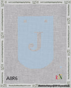 A taped needlepoint canvas with the design: Banner 18 mesh count Curved J White on Light Blue.