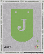 A taped needlepoint canvas with the design: Banner 18 mesh count Curved J White on Light Green.