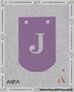 A taped needlepoint canvas with the design: Banner 18 mesh count Curved J White on Purple.