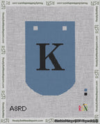 A taped needlepoint canvas with the design: Banner 18 mesh count Curved K Black on Blue.