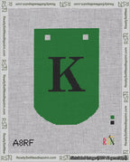 A taped needlepoint canvas with the design: Banner 18 mesh count Curved K Black on Green.