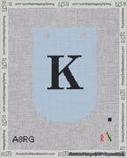 A taped needlepoint canvas with the design: Banner 18 mesh count Curved K Black on Light Blue.